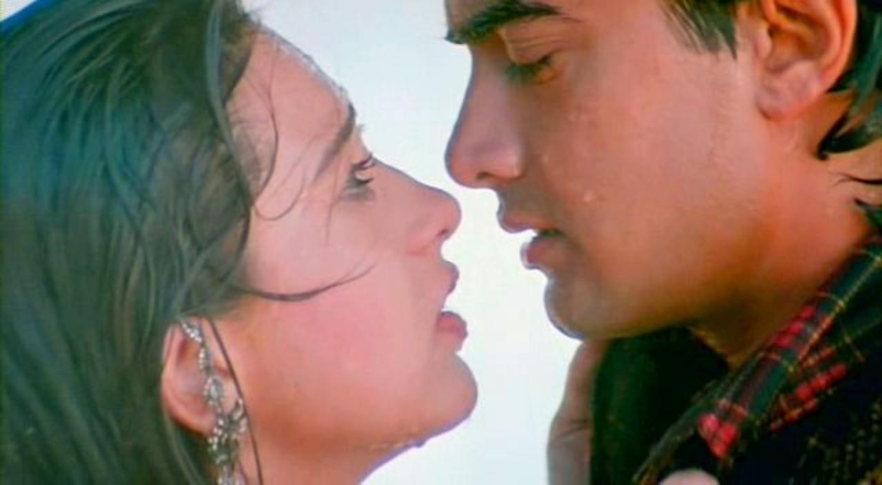 13. Raja Hindustani
During a time when on-screen kissing was still tiptoed around, Aamir Khan and Karisma Kapoor took their love story to new heights with a passionate lip-lock in the rain. This intimate moment symbolized the resolution of their conflicts, bringing harmony back into their world